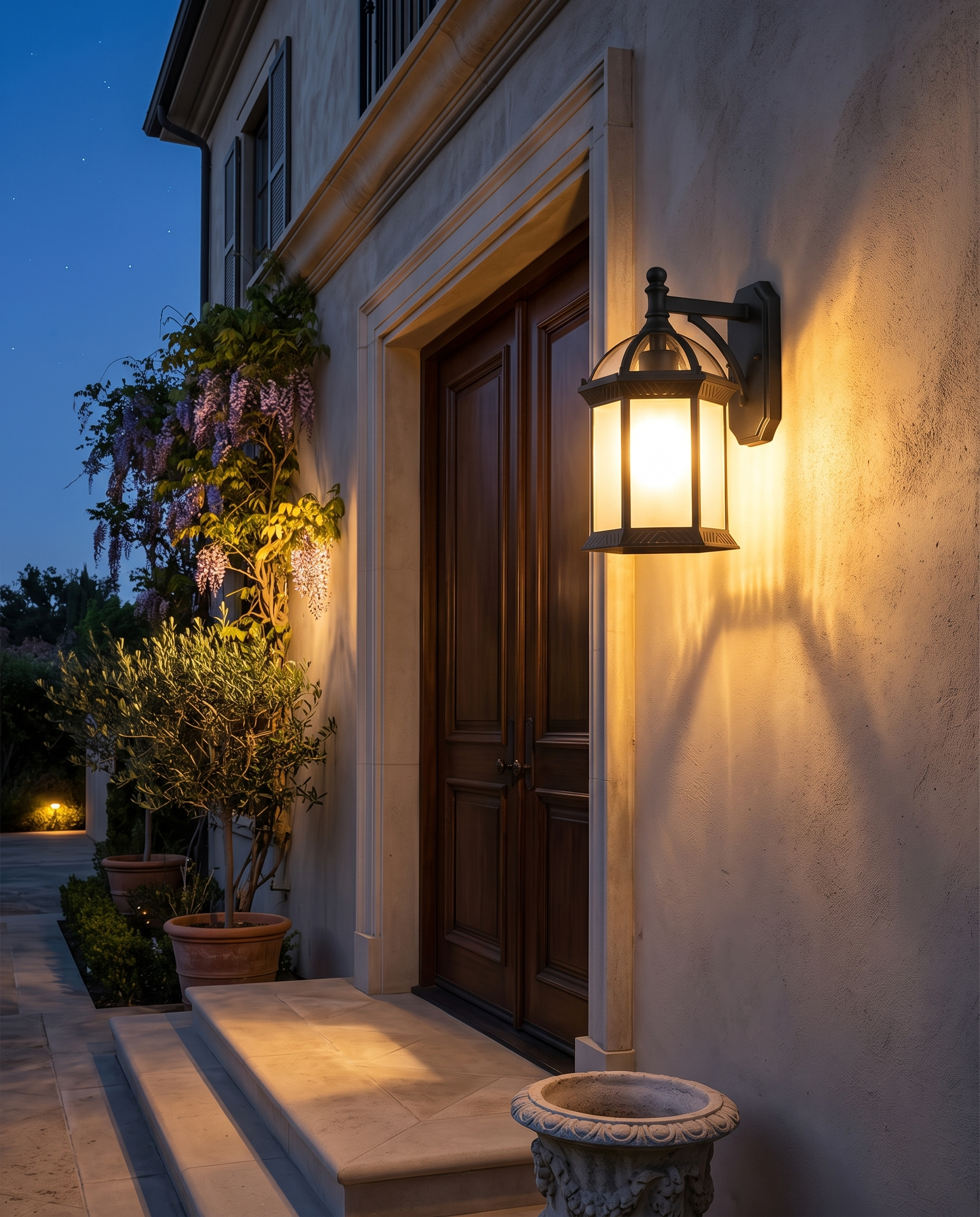 Wall-mount black patio sconce on a villa facade