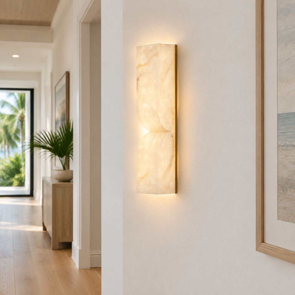Esker Carved Alabaster Wall Sconce, Gold and White Alabaster, in a Florida modern home hallway with light wood floors and white walls