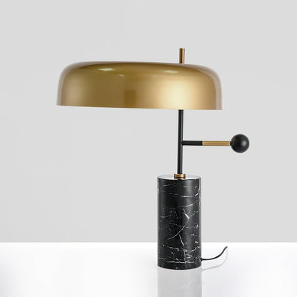 Barclay marble table lamp with gold dome shade on a grey background