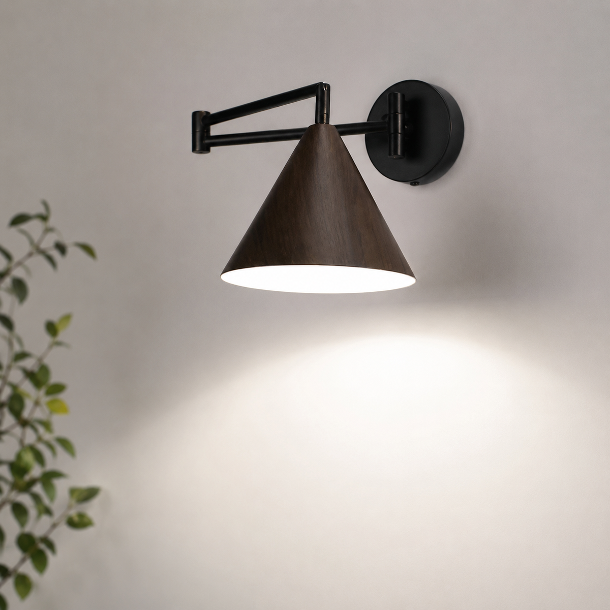Soren Nordic Swing Arm Wall Sconce in Walnut with white light, close-up against a plain wall