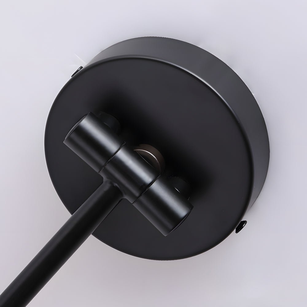 Close-up of the Soren Nordic Swing Arm Wall Sconce matte black wall plate and adjustable knuckle joint