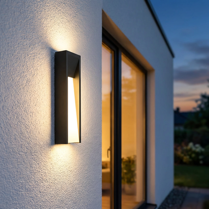 Aurelle wall light on minimalist white stucco wall at twilight