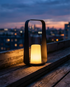 Marin black waterproof outdoor lamp on a balcony railing at dusk
