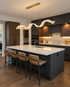 Cirelle gold ribbon wave pendant over a kitchen island