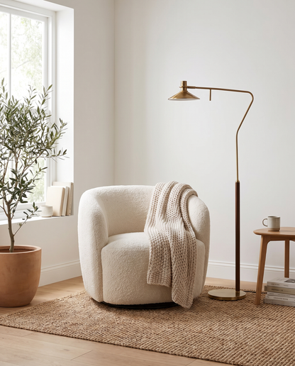 Vintage gold floor lamp in a bright Scandinavian reading nook