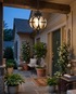 Black orb pendant light on a covered porch