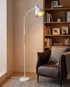 White Alder wood arc floor lamp in a reading nook