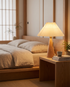 Yumi Table Lamp in Light Brown on a bedroom nightstand