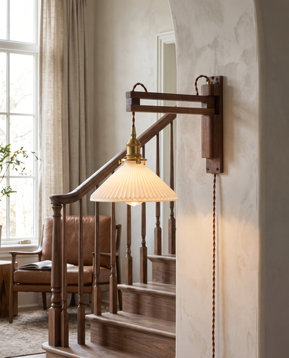 Bjork Glass Wall Sconce in Walnut beside a staircase