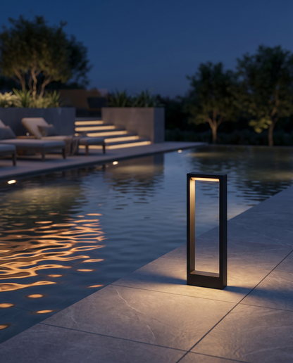 Vialo Outdoor Bollard Light by a poolside terrace
