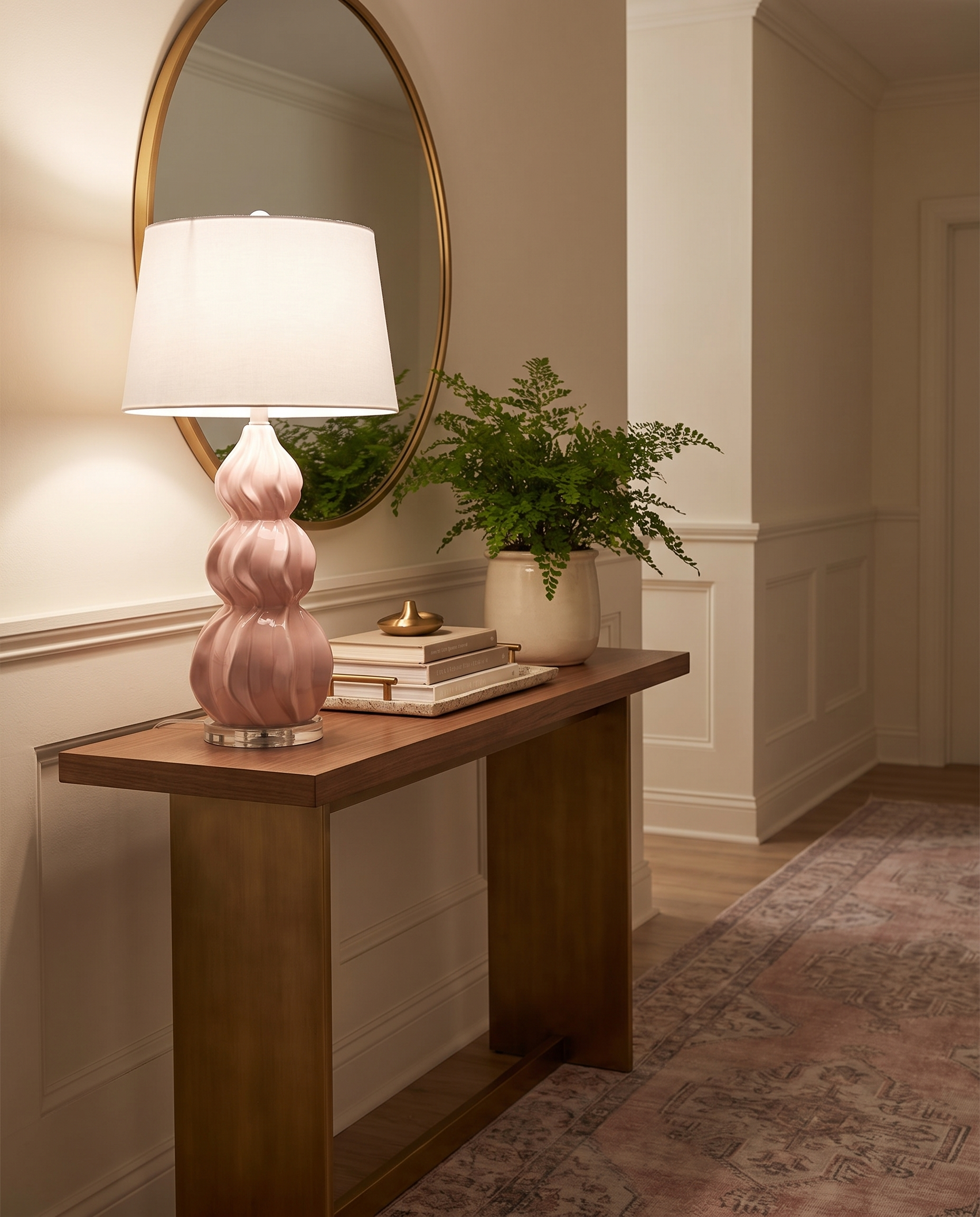Juno pink ceramic gourd table lamp on a hallway console