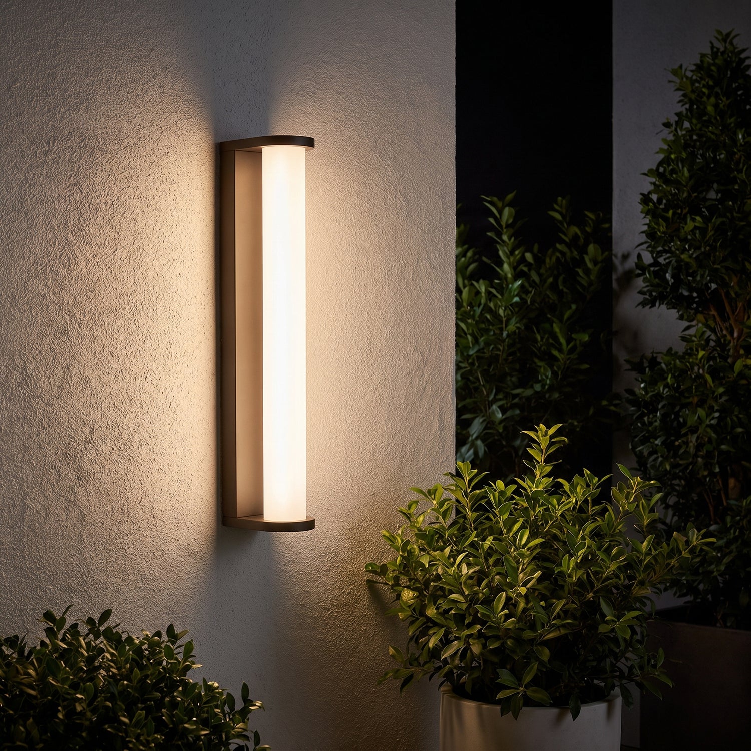 Lumira bronze tube outdoor wall sconce on a patio wall