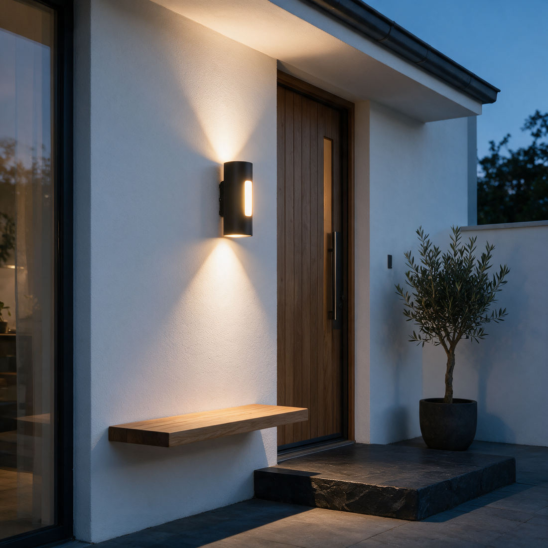 Halden black up down outdoor wall light beside a modern front door at dusk