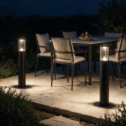 Marlow bollard lights bordering a limestone terrace with outdoor dining at night