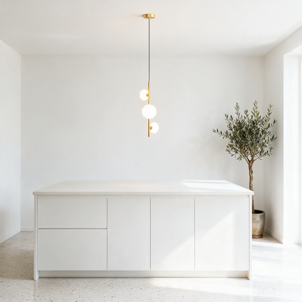 Tresa 3 Light Linear Pendant Light in Gold and White above a bright minimalist kitchen island with white quartz