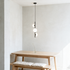 Tresa 3 Light Linear Pendant Light in Black and White above a Scandinavian dining nook in bright daylight