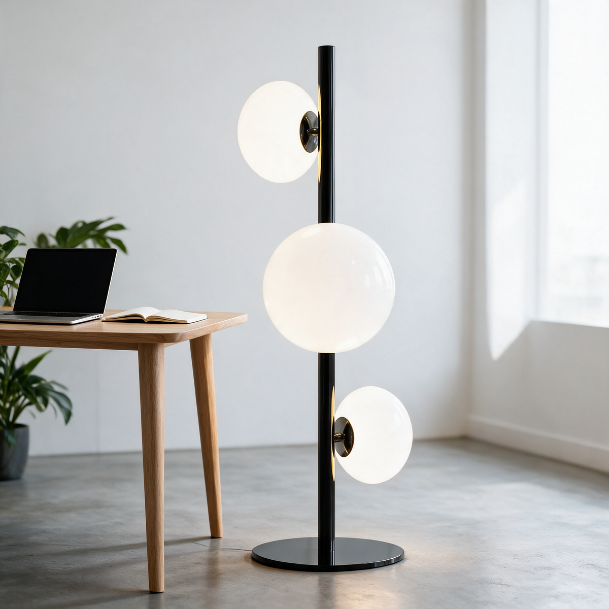 Juniper Floor Lamp in Black and White beside a desk in a bright home office