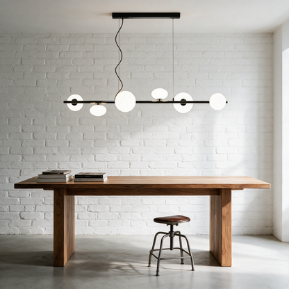 Meridian Linear Chandelier in Black and White above a studio worktable in a creative workspace