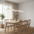 Wilder white multiwave LED chandelier over a Scandinavian oak dining table