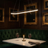 Wynn black curved rectangle ring pendant over a restaurant banquette table