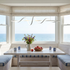 Vela rotating ring LED chandelier in white over a coastal breakfast nook table