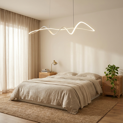 Wren white wave line LED chandelier above a minimalist bedroom platform bed