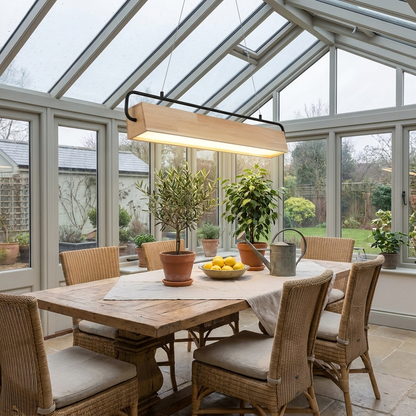 Truett wood rectangle LED pendant light in a conservatory dining space