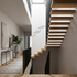 Theron black Z shape linear LED chandelier in a double height stairwell