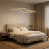 Theron gold Z shape linear LED chandelier in a warm minimalist bedroom
