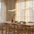 Tallis white acrylic wavy LED pendant light over a Scandinavian oak dining table