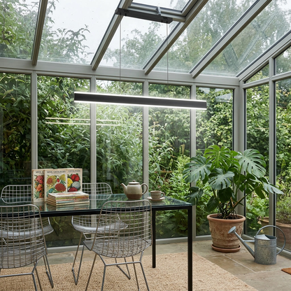 Sinclair black up and down island light in a glass conservatory dining space