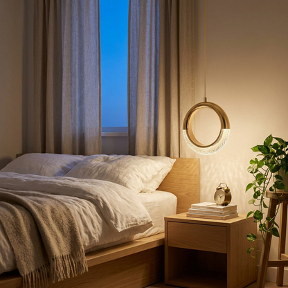 Sandrine gold ring LED pendant light beside a bed in a minimalist bedroom