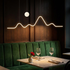 Sullivan black mountain moon LED chandelier over a restaurant banquette table
