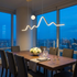 Sullivan gold mountain moon LED chandelier over a penthouse dining table