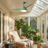 Kestral green ceiling fan light in a leafy garden sunroom