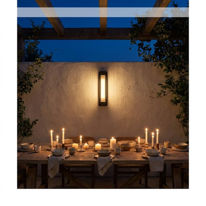 Slim wall sconce lighting an evening patio dining area with timber table under a pergola