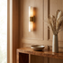 Marbeuf Vertical Marble Wall Sconce gold in a panelled entryway above a console