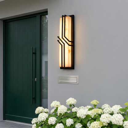 Faux marble outdoor wall light on grey render facade beside dark green front door
