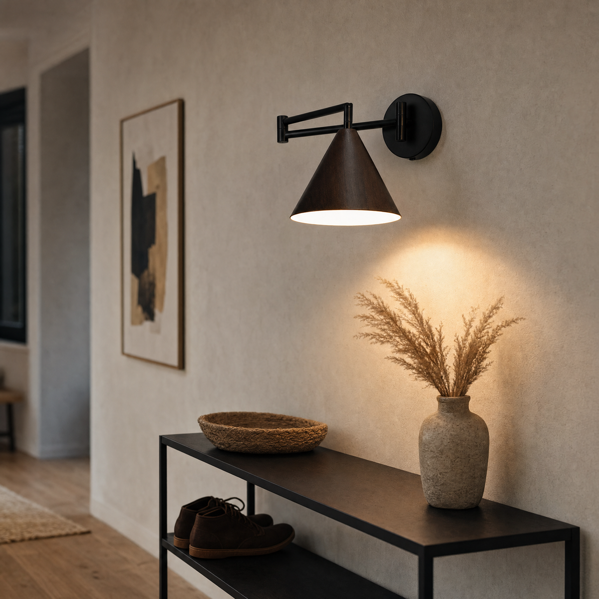 Soren Nordic Swing Arm Wall Sconce in Walnut with warm light above an entryway console table