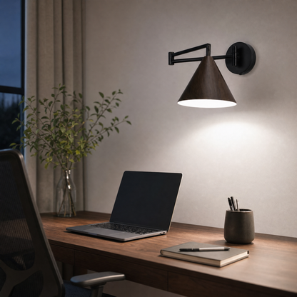 Soren Nordic Swing Arm Wall Sconce in Walnut with white light above a home office desk