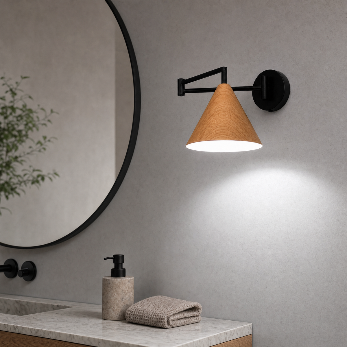 Soren Nordic Swing Arm Wall Sconce in Wood with white light beside a round bathroom vanity mirror