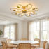 Daisy gold iron flower ceiling light above a bright dining room with round table