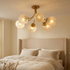 Verriere carved glass brass semi flush ceiling light in an elegant bedroom