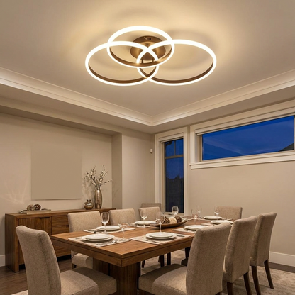 Cirque three ring LED ceiling light above a dining room table