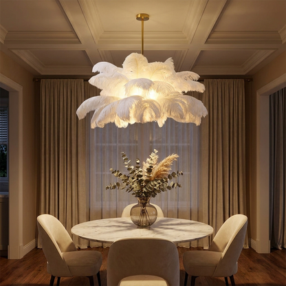 Plume white feather ceiling light above a round marble dining table