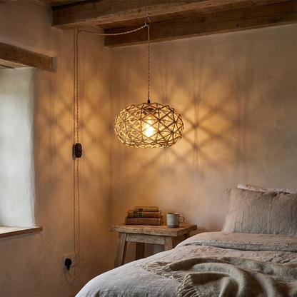Nessa hand woven rope plug in pendant light beside a rustic bed