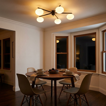 Brume glass bubble ceiling light above a round walnut dining table