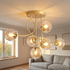 Lenore gold chandelier with cognac glass globes in a Nordic living room