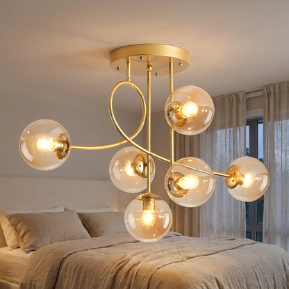 Lenore gold chandelier with cognac glass globes in a calm bedroom