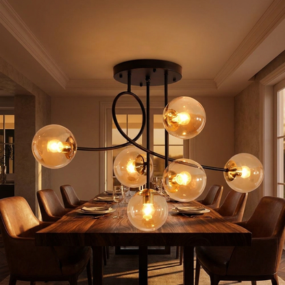 Lenore black chandelier with cognac glass globes above a dining table